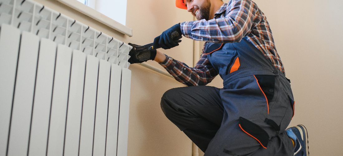 Man replacing radiator