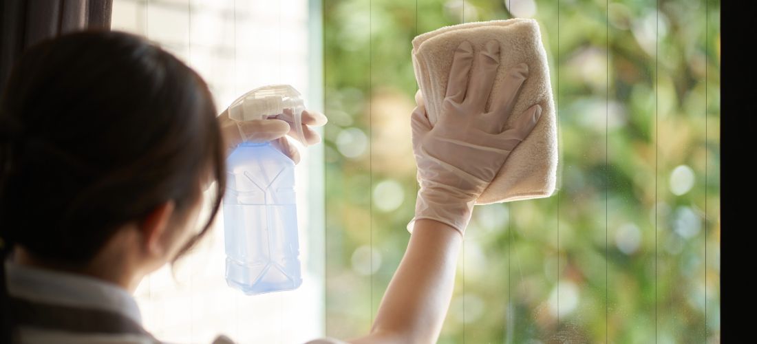 woman cleaning window