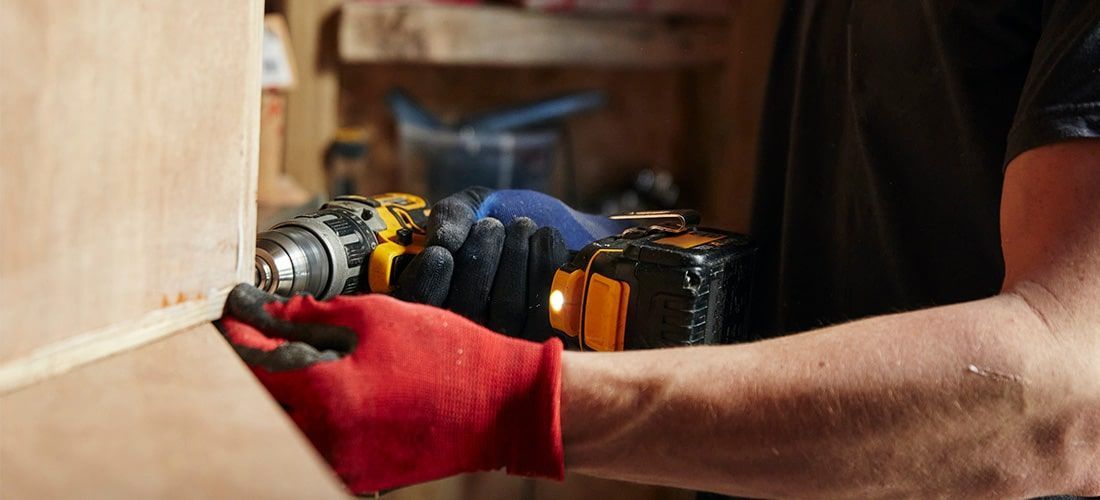 Carpenter building using a drill driver.