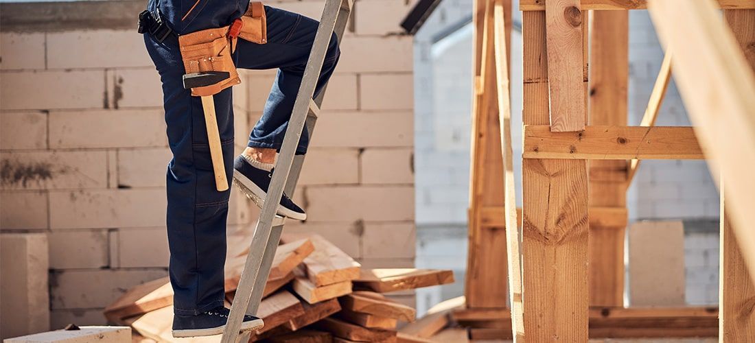 man climbing a roof ladder