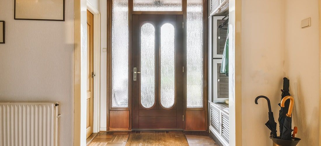 Wooden front door with frosted glazing.