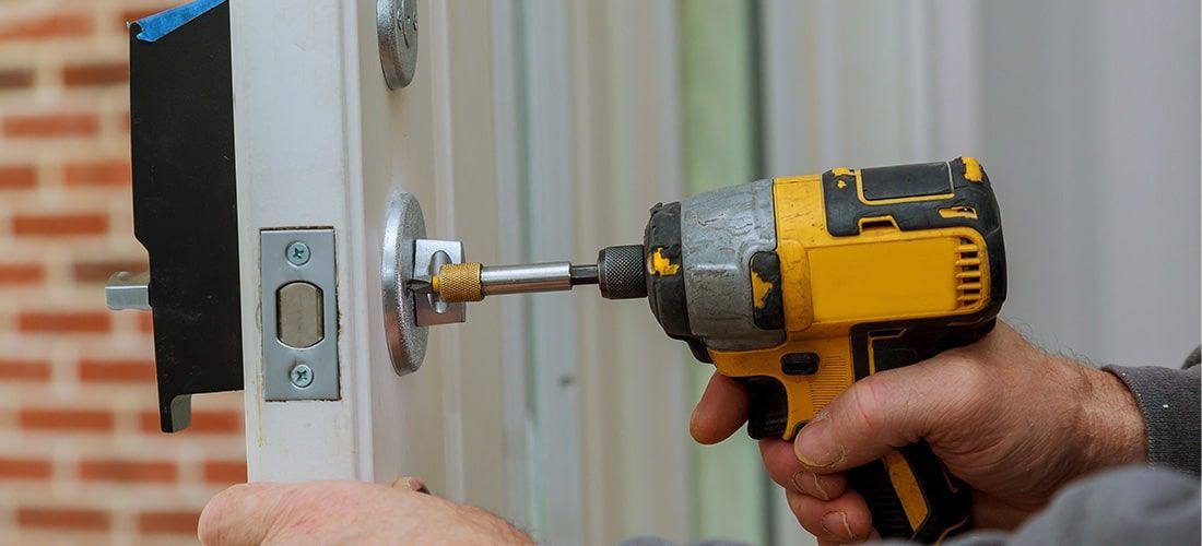 Homeowner installing new front door lock.