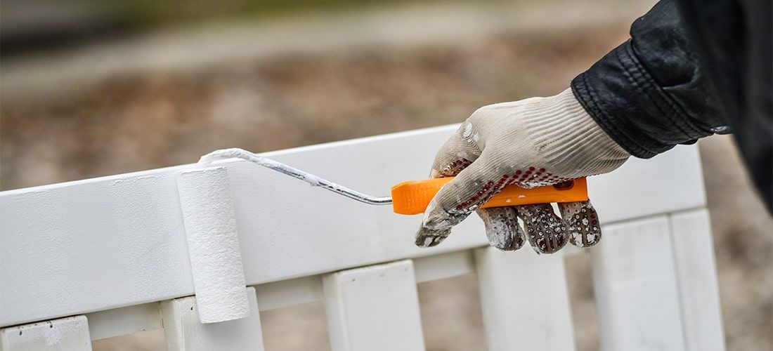 man painting garden furniture