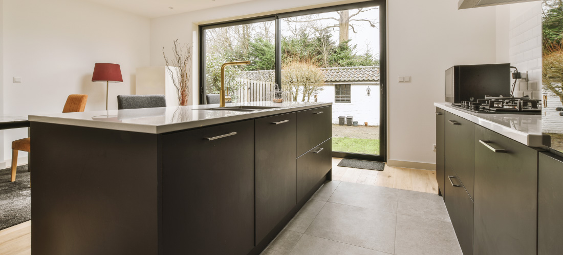 Modern kitchen in front of patio doors.