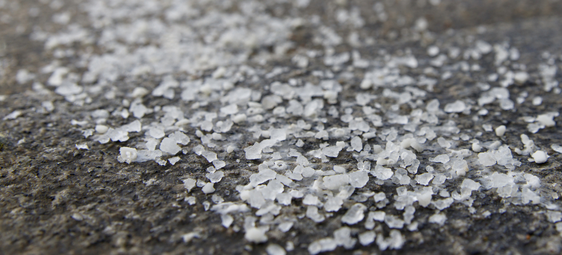 Salt and grit being used on pavement