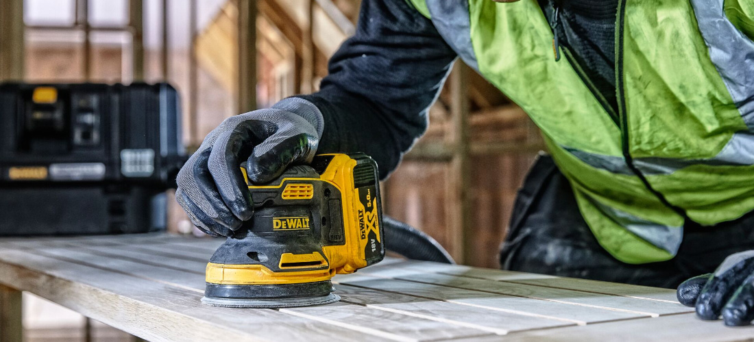 Tradesperson using DeWALT sander.