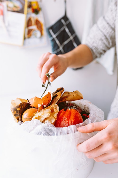 Food waste bin full of vegetables and peels.