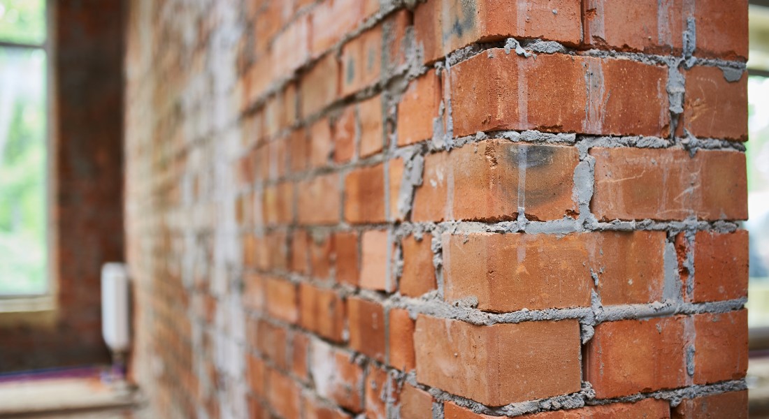 Freshly built brick wall in house construction.