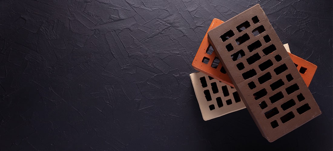 Black, orange and white air bricks stacked on top of one another.