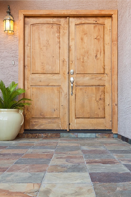 Wooden exterior facing double door.