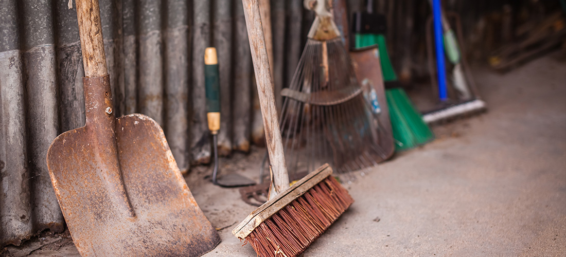 Dirty garden tools in a shed.