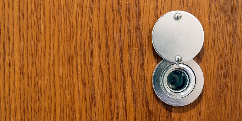 Open peep hole in wooden door.