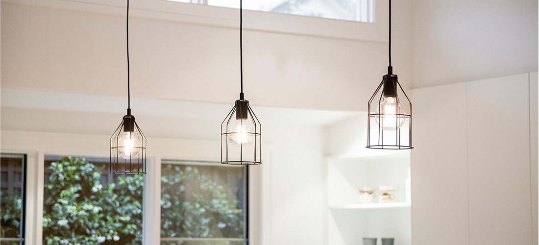 Three matching pendant lights in modern living space.