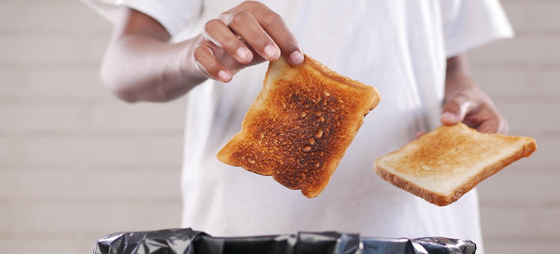 Man throwing toast into a bin.