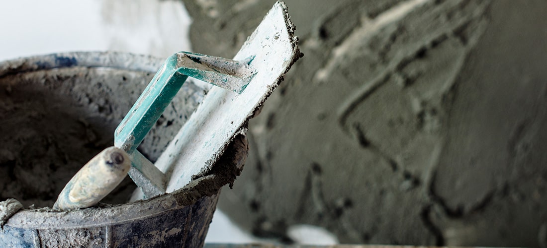 Well used cement plaster sitting in bucket.