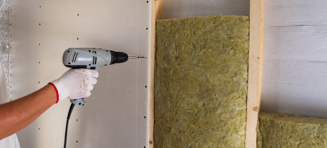 Worker installing insulation